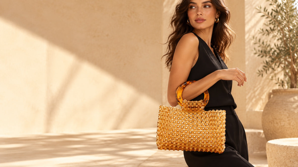 GO2SHINY amber beaded tote carried with a black outfit in a sunlit interior